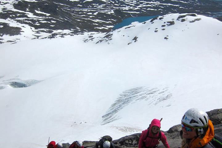 a group of people standing on top of a snow covered slope