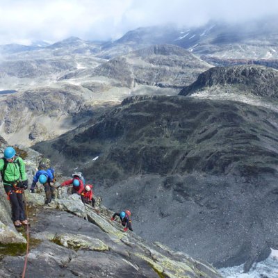 a man riding on top of a snow covered mountain
