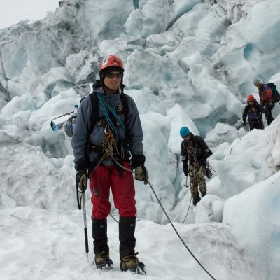 a man standing on top of a snow covered mountain