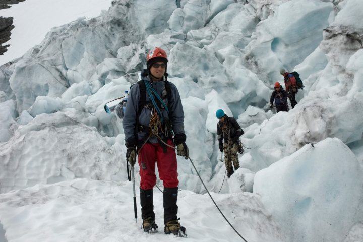 a man standing on top of a snow covered mountain