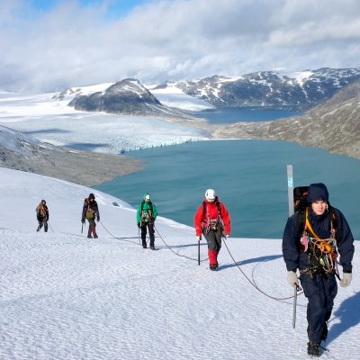 a group of people riding skis on a snowy mountain