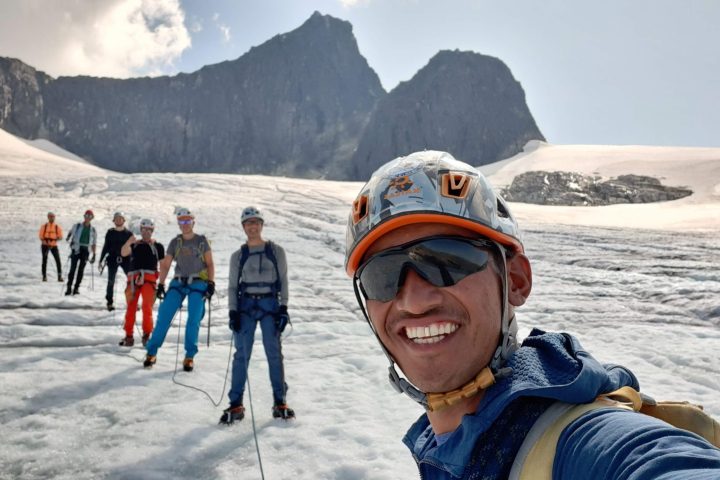 a group of people riding skis on a snowy mountain