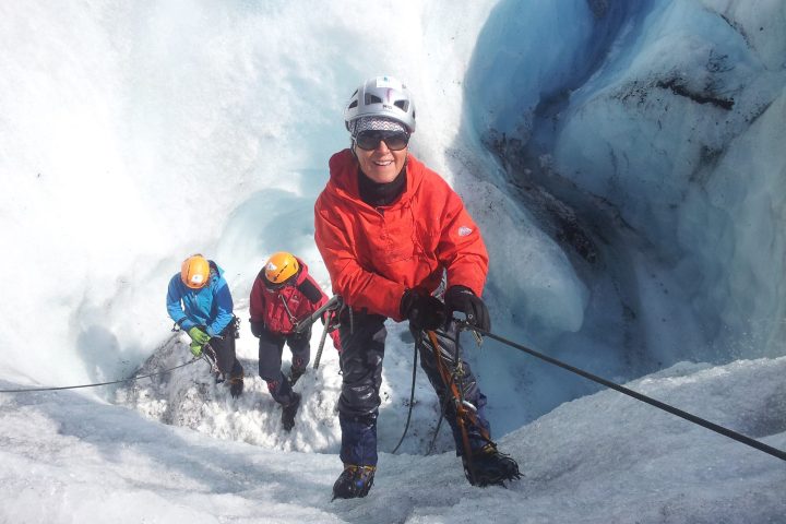 a man riding a snowboard down a snow covered slope