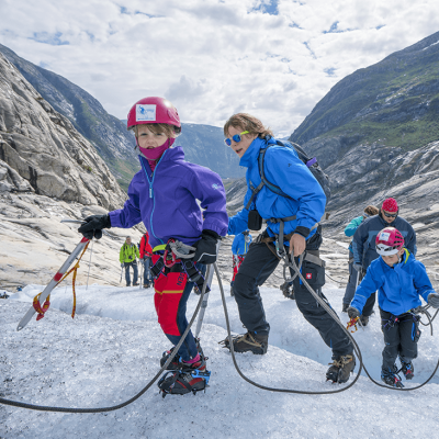 a group of people riding skis on a snowy mountain