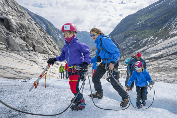 a group of people riding skis on a snowy mountain