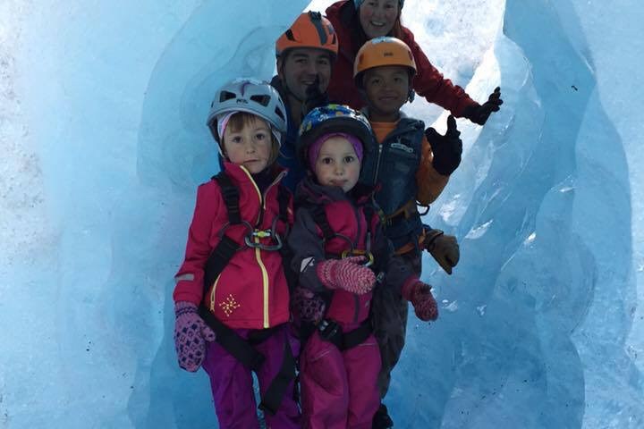Group of people wearing helmets in an ice cave.