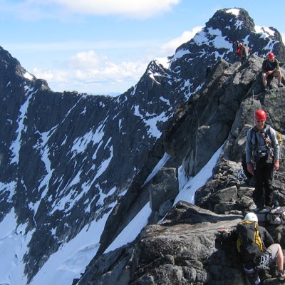 a man standing on top of a snow covered mountain