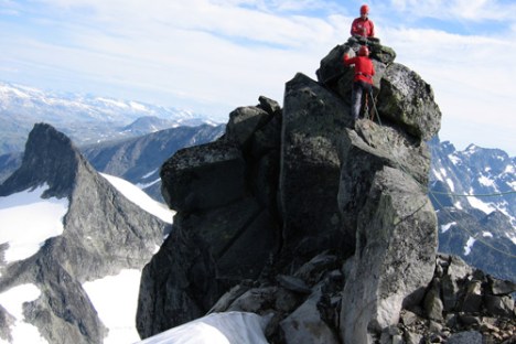 a man standing on top of a snow covered mountain