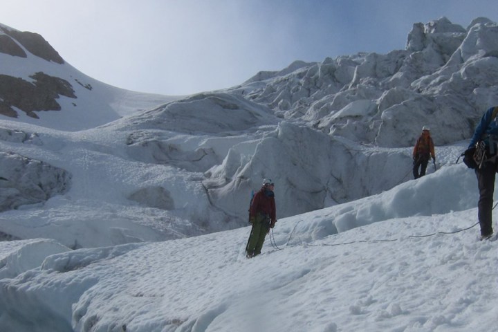 a man standing on top of a snow covered mountain