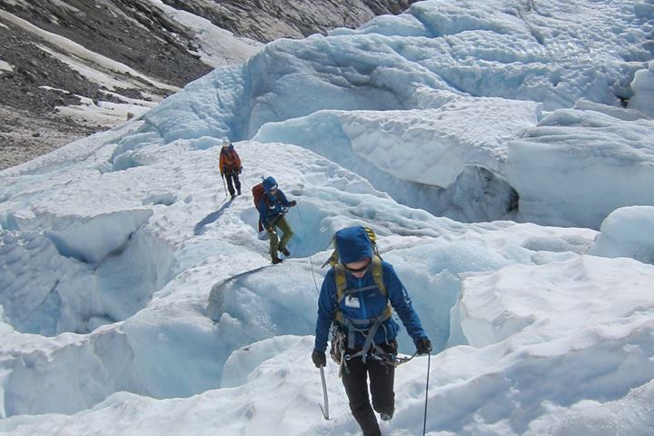 a man walking across a snow covered mountain