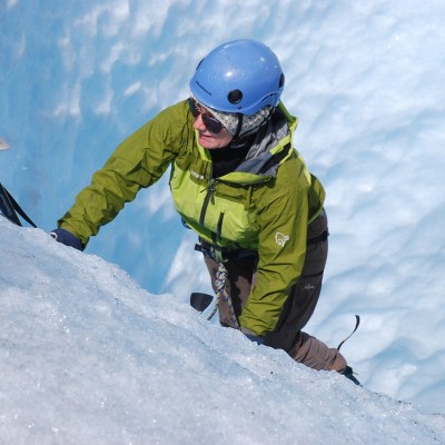 a man riding a snowboard down a snow covered slope
