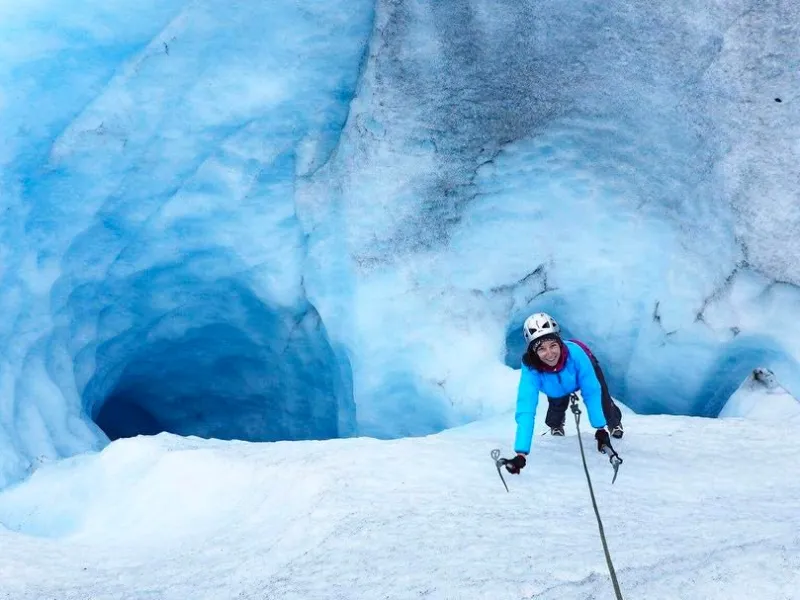 a man riding skis down a snow covered slope