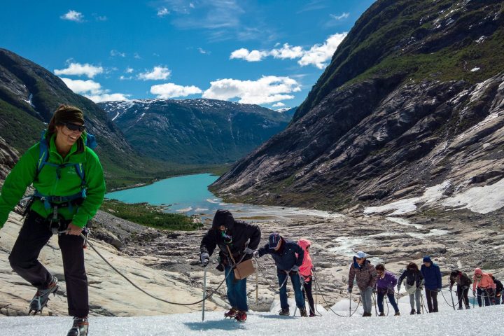 a group of people standing on top of a snow covered mountain