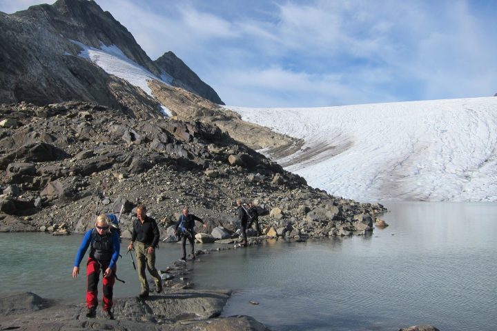 a group of people standing on top of a mountain