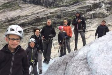 a group of people standing on top of a snow covered mountain