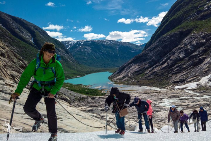 a group of people standing on top of a snow covered mountain