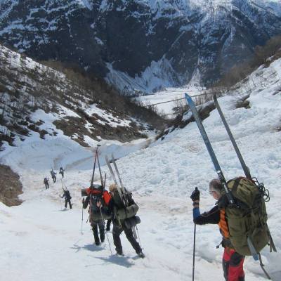 a group of people riding skis on top of a snow covered mountain