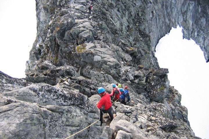 a man standing on a rocky hill
