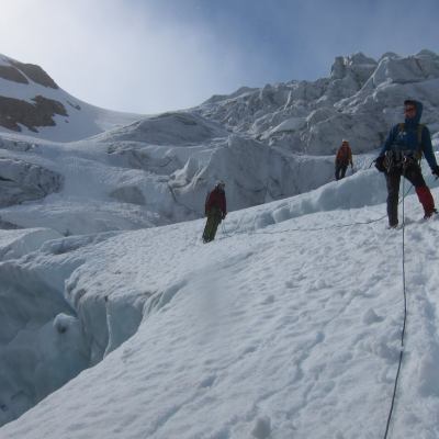 a man riding a snowboard down a snow covered mountain