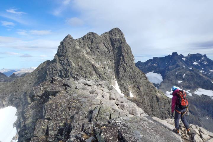 a man standing on a rocky hill