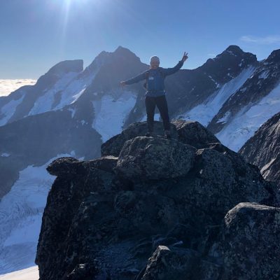 a man standing on top of a snow covered mountain
