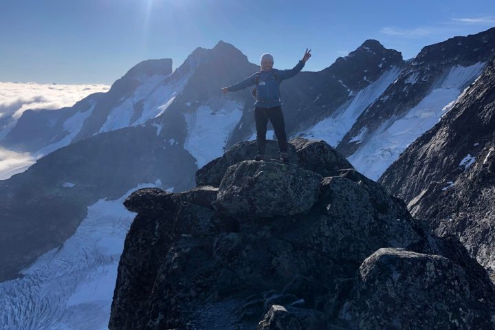 a man standing on top of a snow covered mountain