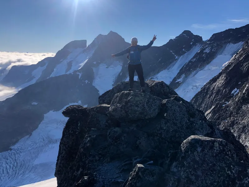 a man standing on top of a snow covered mountain
