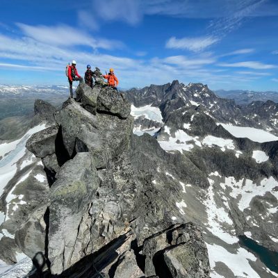 a man flying through the air on a snow covered mountain