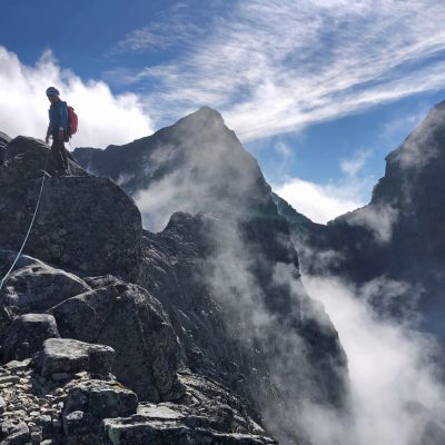 a person flying through the air on a rocky hill