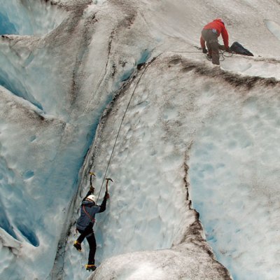 a man riding on the back of a large rock