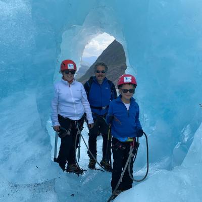 A group of people standing in a tunell on the Nigardsbreen glacier
