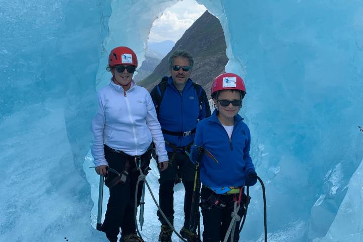 A group of people standing in a tunell on the Nigardsbreen glacier