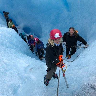 Jonathan Kimmel et al. riding skis down a snow covered slope